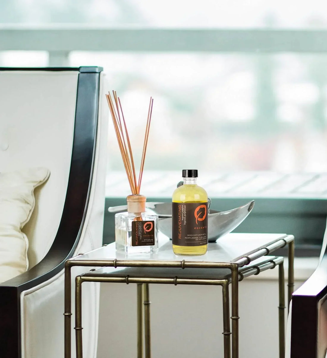 Escents essential oil diffuser placed on a bedside table in a cozy home setting | Escents Aromatherapy
